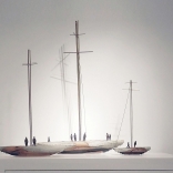 Three model boats, of different sizes with long bronze masts and clay base, produced by contemporary Greek artist Eleni Kolaitou of the Greek art gallery Asimis