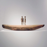 Two figurine sculptures standing on a clay boat as seen in the Greek art gallery, Asimis in Santorini