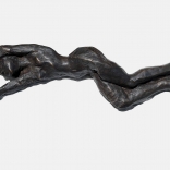 A lying bronze sculpture with hands thrown over the top, sculpted by Greek contemporary artist, Eleni Kolaitou of the Greek art gallery, AK Santorini,Greece