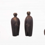 Four differently sized bronze sculprures representing men in suits, produced by Greek contemporary artist Eleni Kolaitou of the Greek art gallery, AK, Santorini